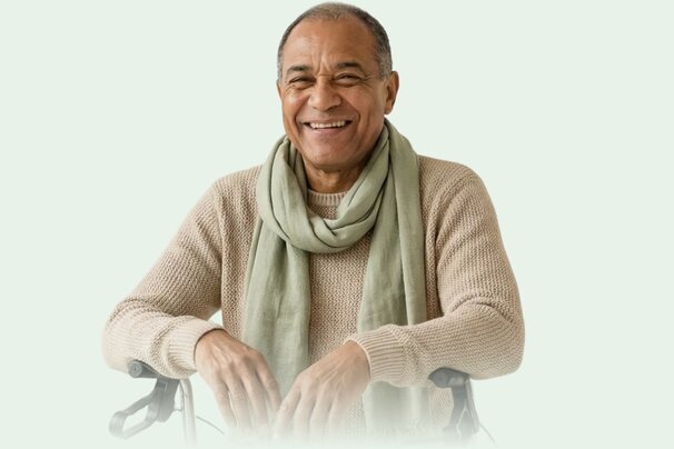 Happy senior man sitting in a rollator