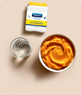 Thickened meal in a bowl and thickened water in a glass