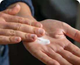 Image of person applying hand lotion