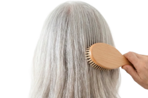 Senior woman brushing her hair