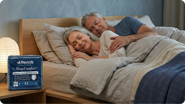 Couple sleeping next to Attends SleepComfort product