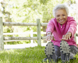 Image of a woman stretching in the grass