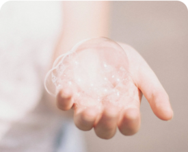 Image of an adult hand holding bubbles in their palm.