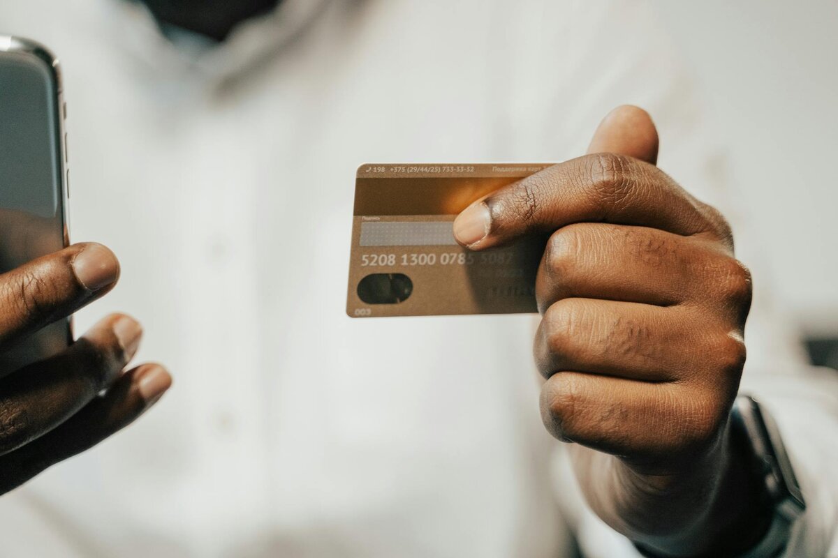 man holding new balance transfer credit card