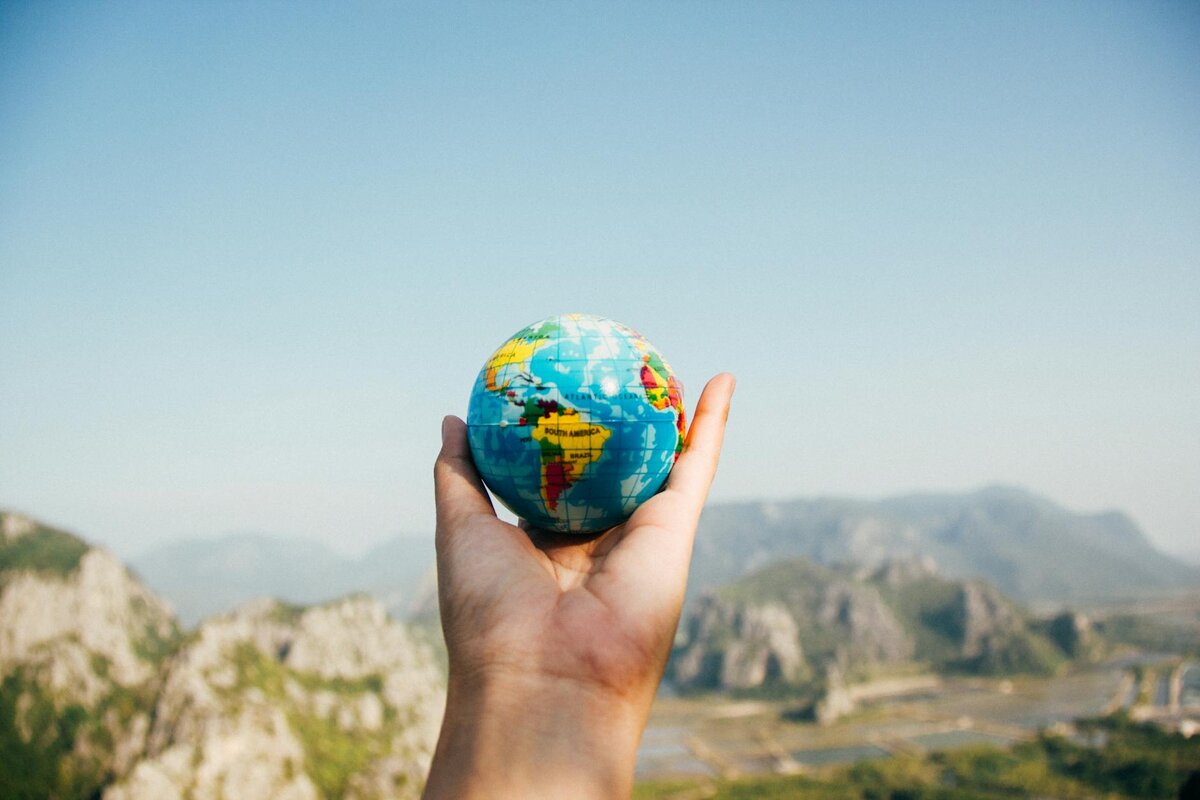 hand holding small globe