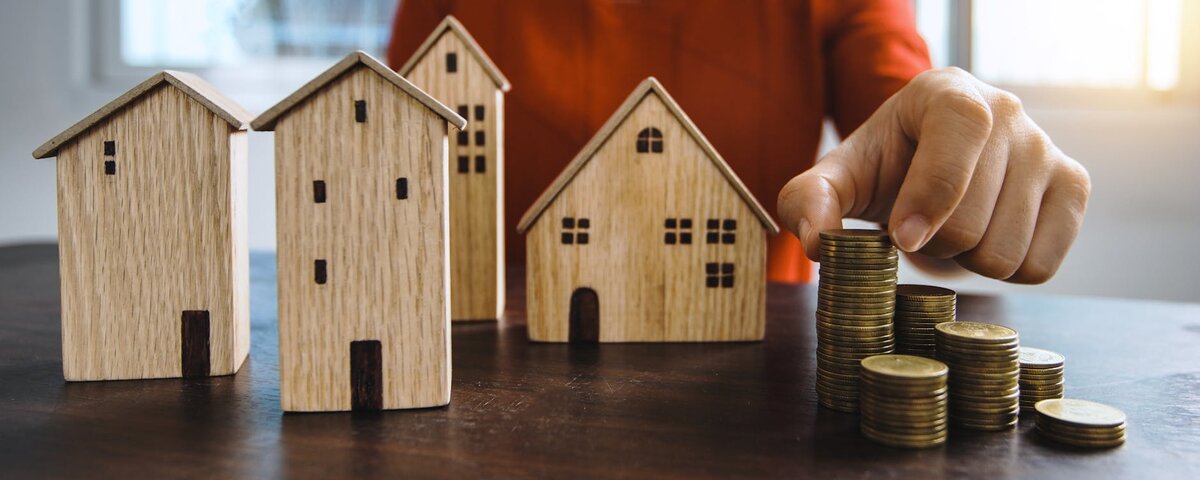 Wooden houses and coins - representing HELOC