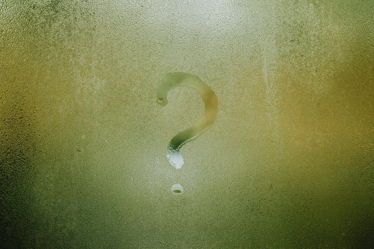 question mark on glass drawn in condensation