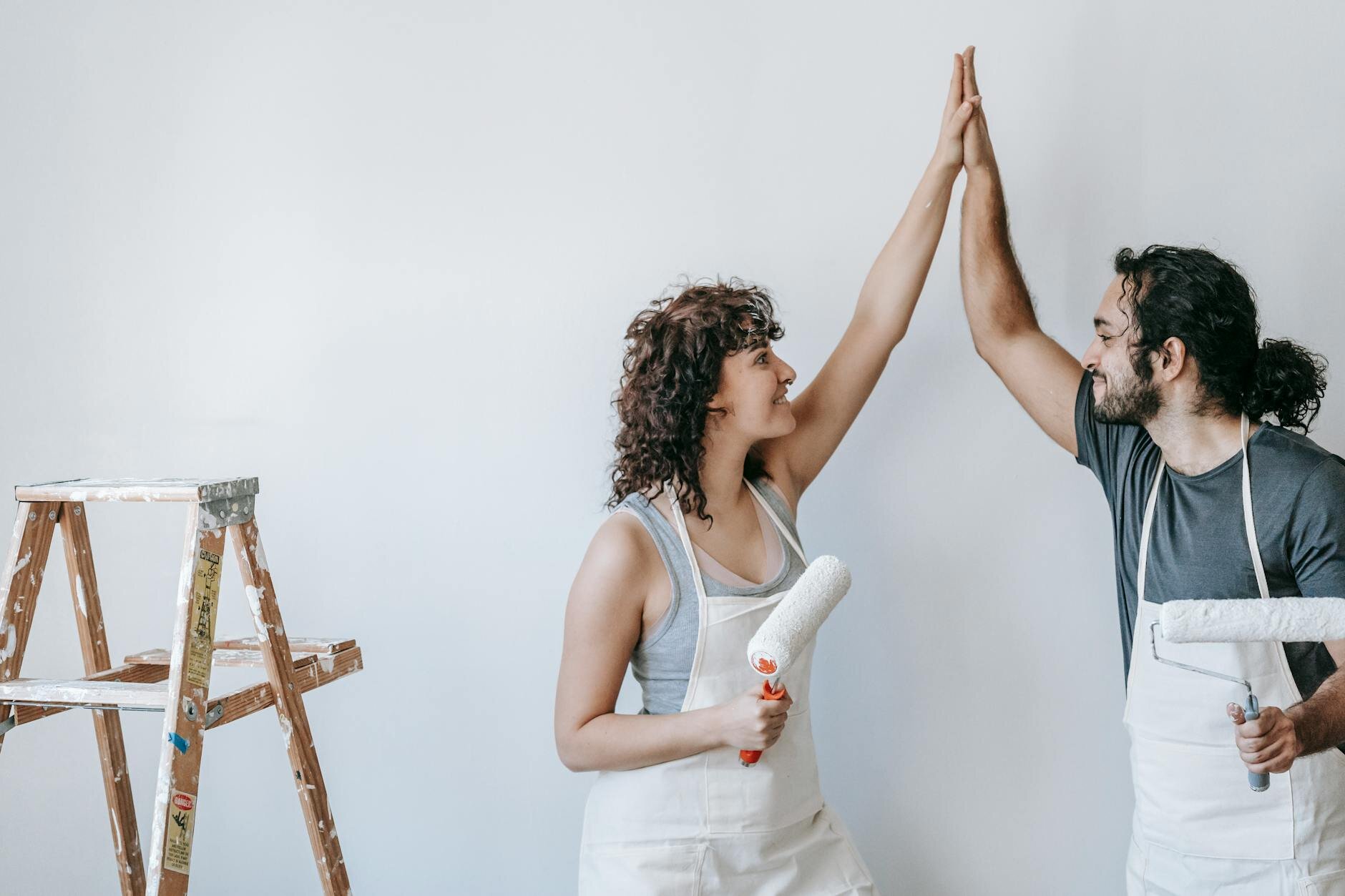 Couple painting house