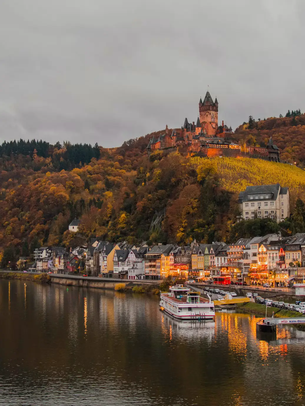 Reichsburg Cochem castle on a hillside overlooking the Moselle River and riverside village