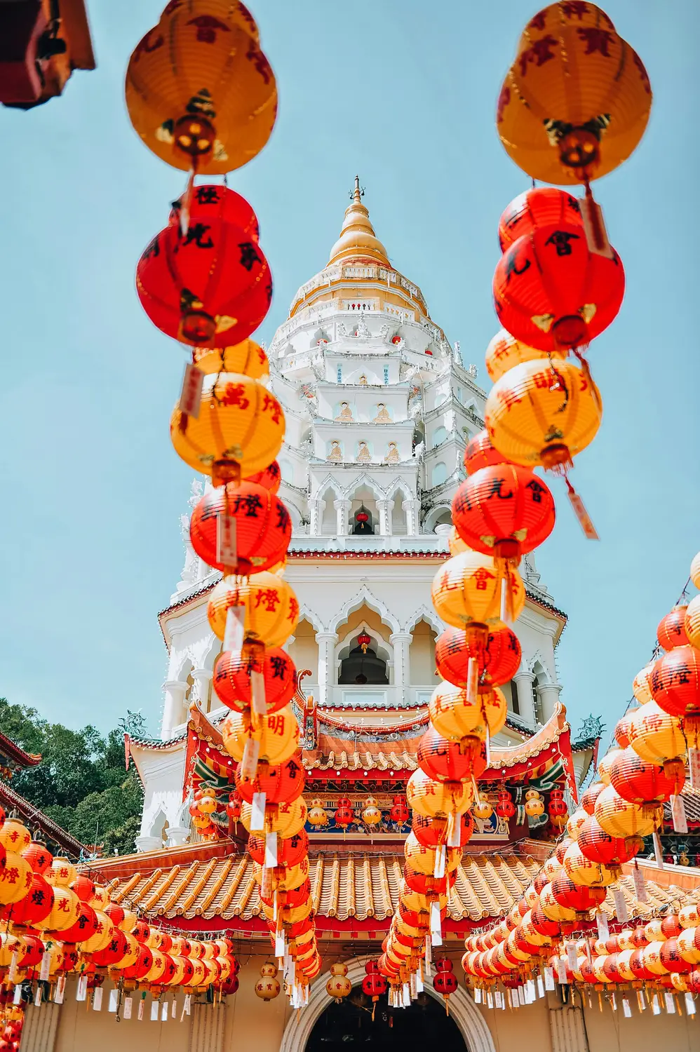 Kek Lok Si Buddhist temple pagoda tower decorated with red Chinese lanterns during Chinese New Year celebration in Penang Malaysia
