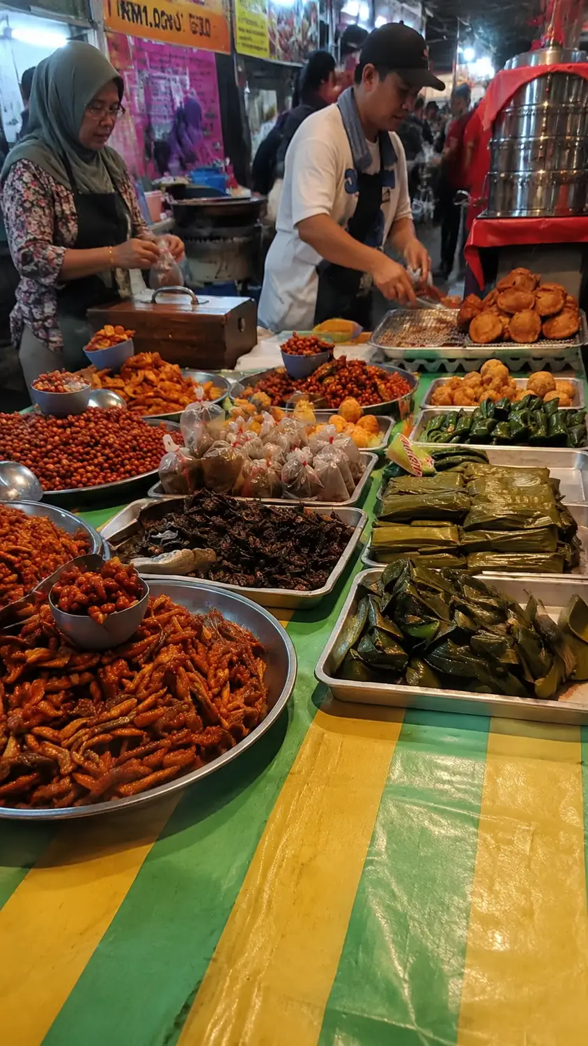 Traditional Malay street food market stalls selling kuih, fried snacks and banana leaf wrapped delicacies, Brunei