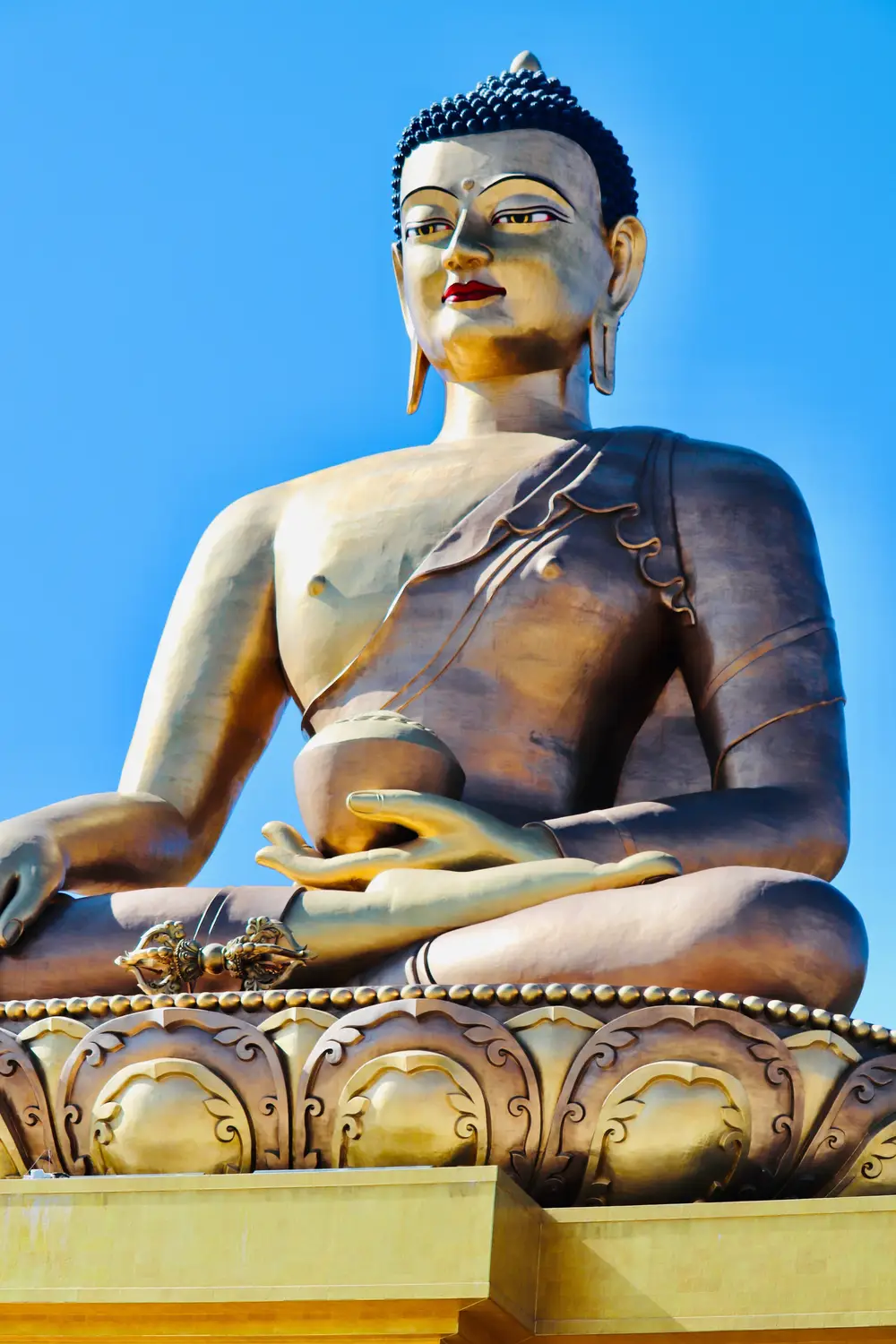 Golden Buddha Dordenma statue seated in meditation against a clear blue sky in Thimphu, Bhutan.