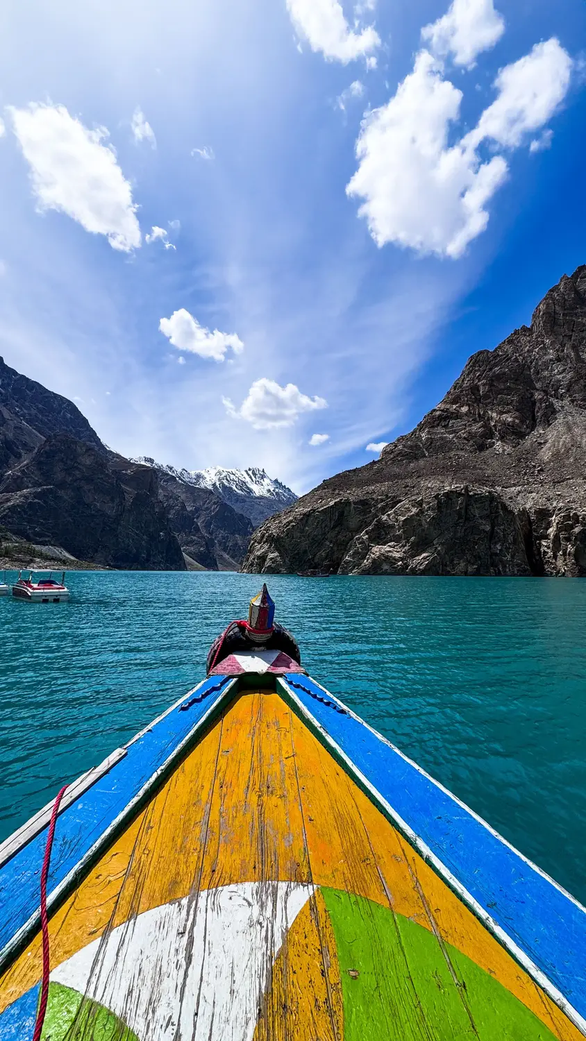 Colorful wooden boat bow on turquoise Satpara Lake with mountain backdrop Skardu Pakistan