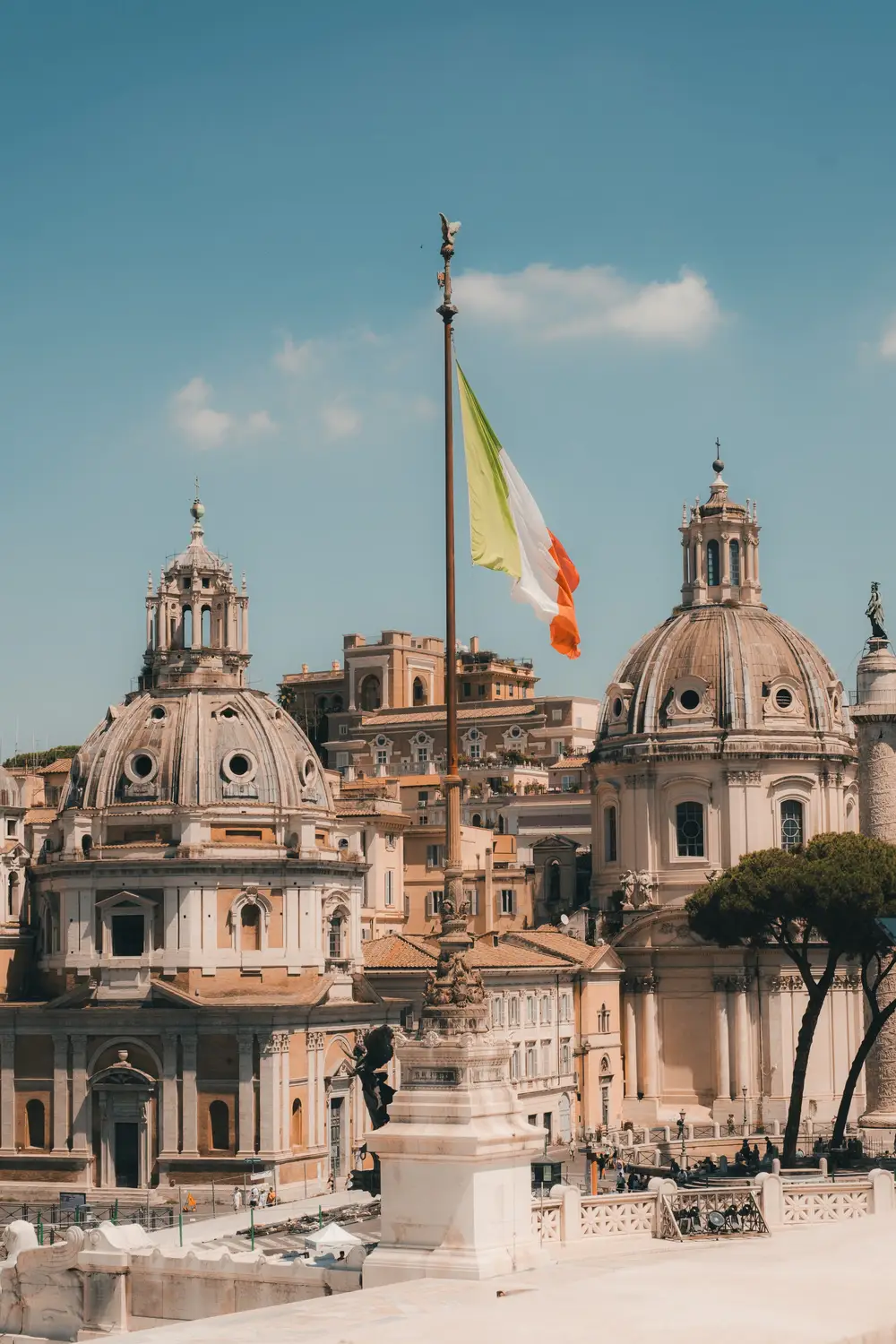 Piazza Venezia in Rome with the Italian flag and Trajan's Column