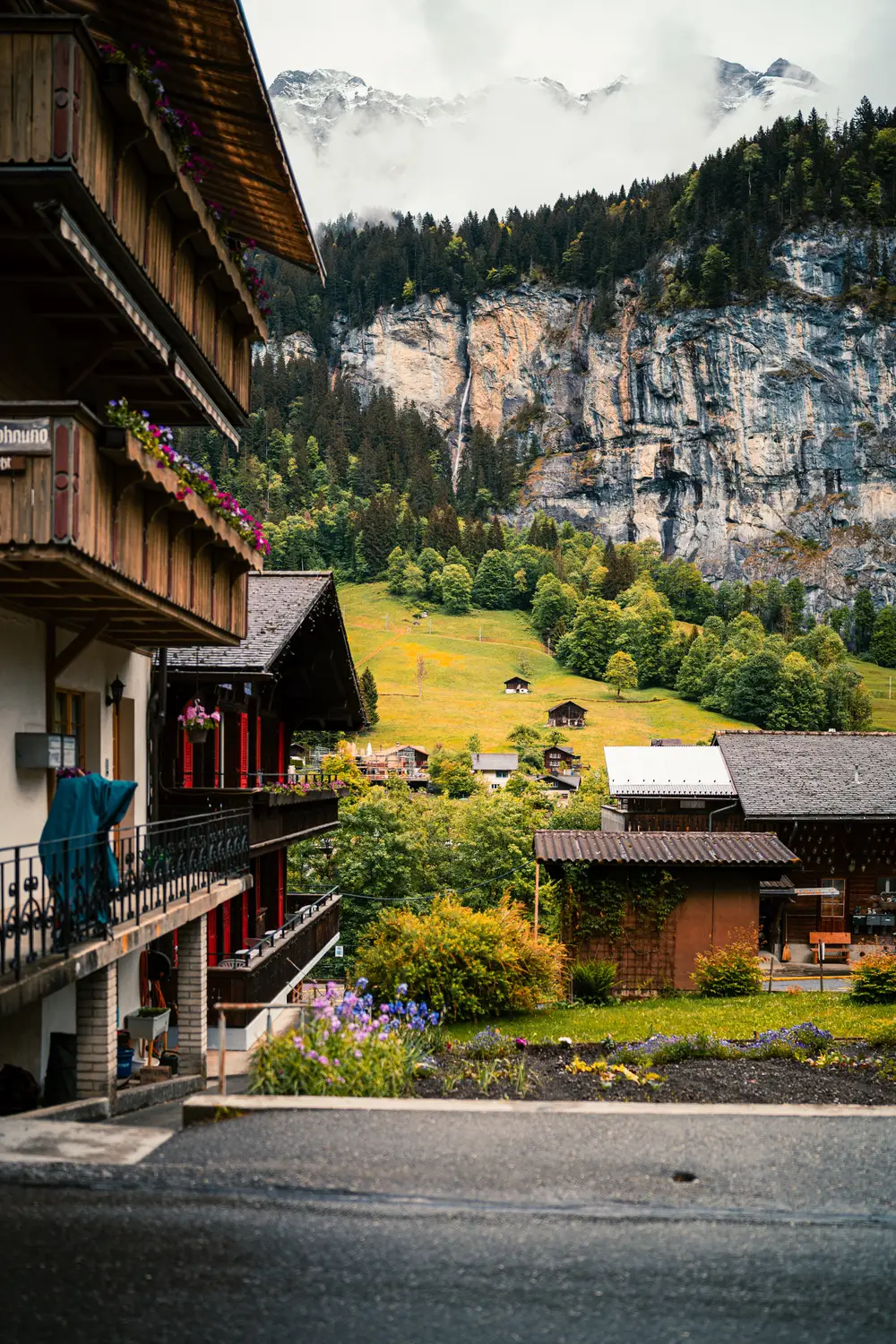 Traditional wooden chalet balcony overlooking a green alpine hillside, Switzerland