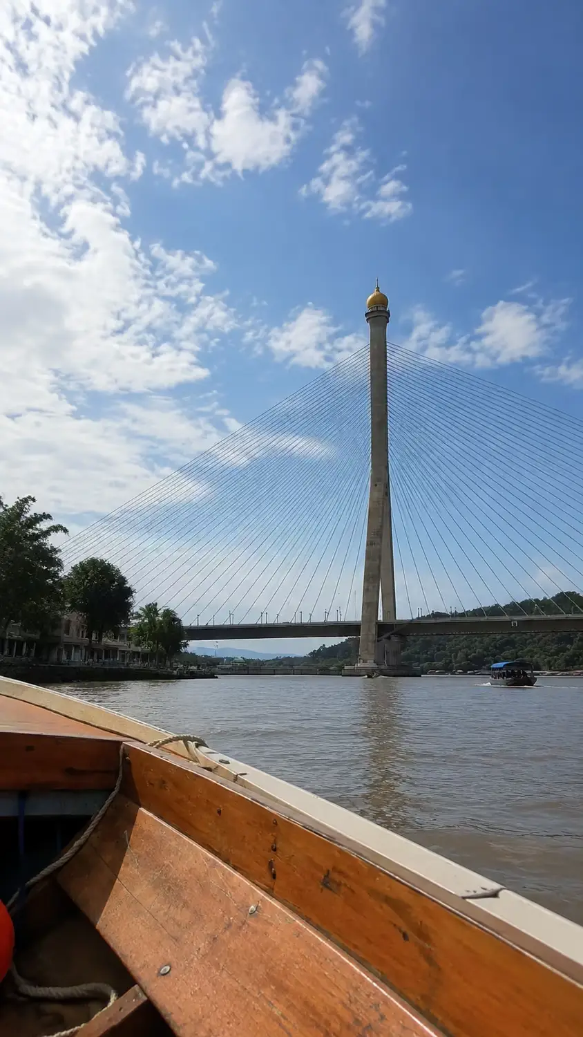 Sungai Kebun Bridge cable-stayed bridge over Brunei River viewed from traditional wooden water taxi, Bandar Seri Begawan