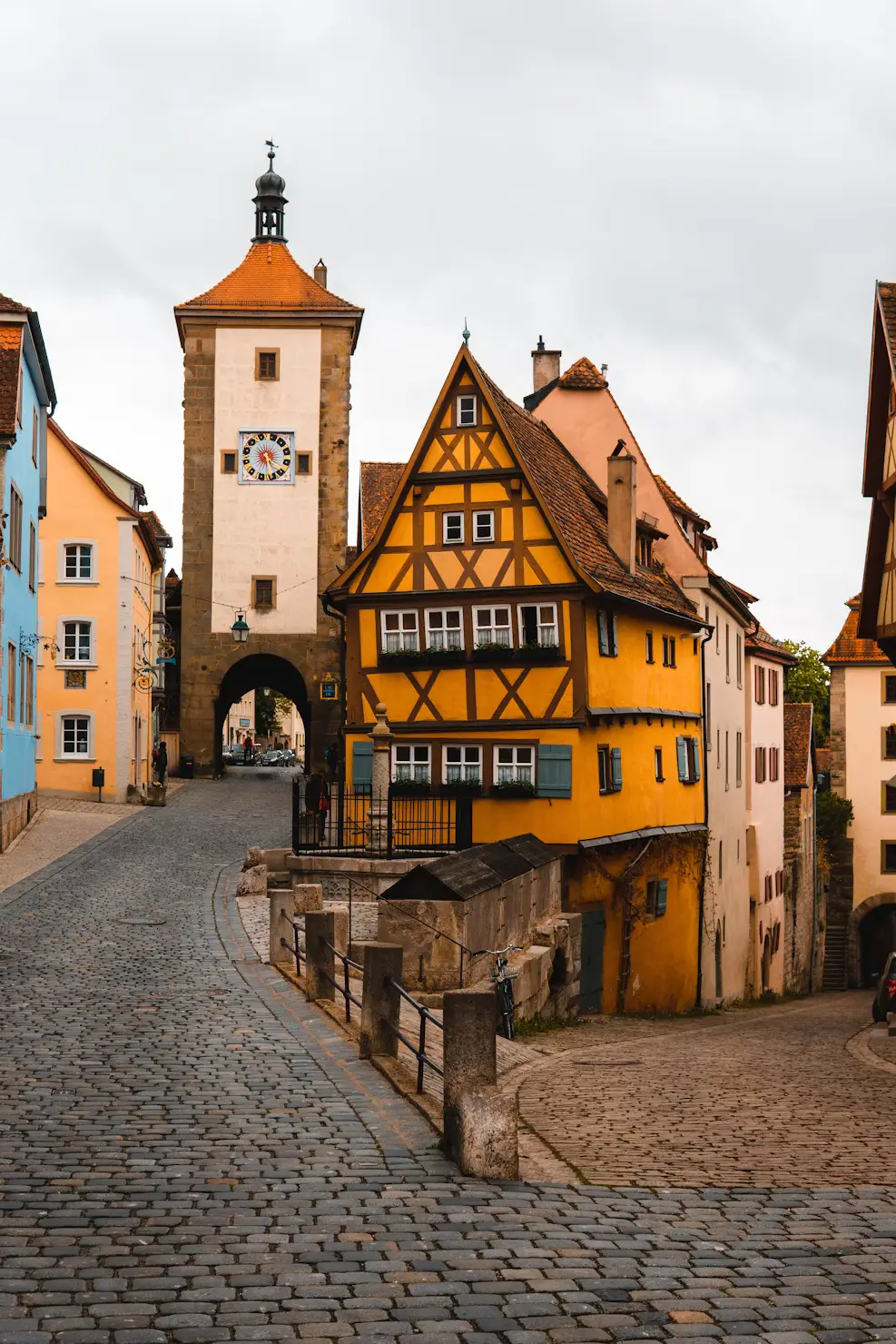 Cobblestone lane leading to a historic half-timbered gate tower in a German old town