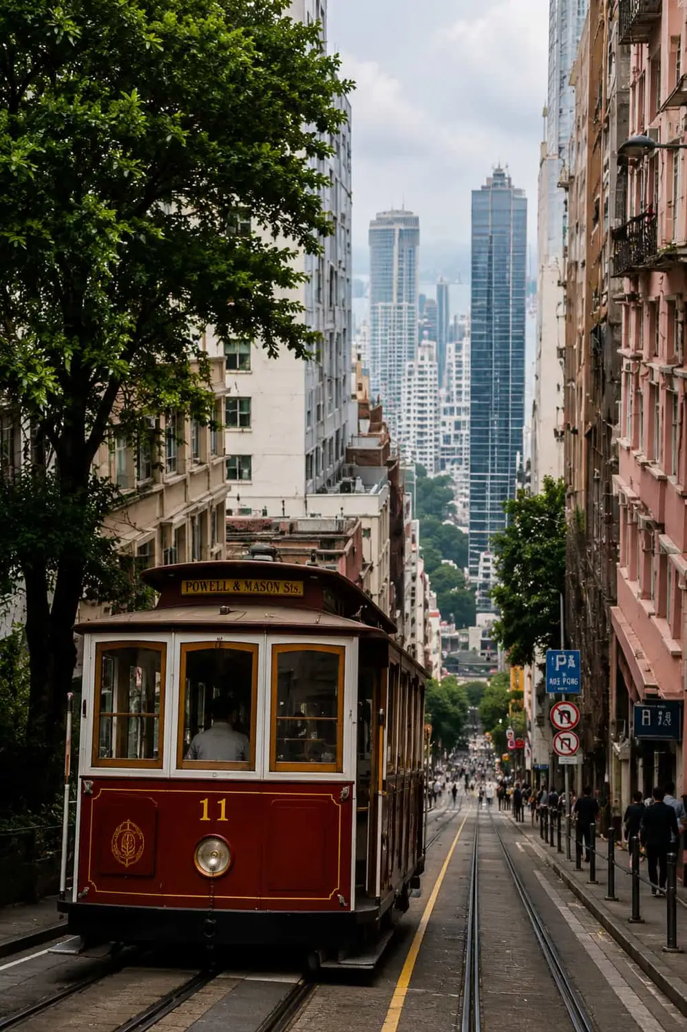 Vintage red Peak Tram climbing a tree-lined street with skyscrapers towering in the background in Hong Kong.