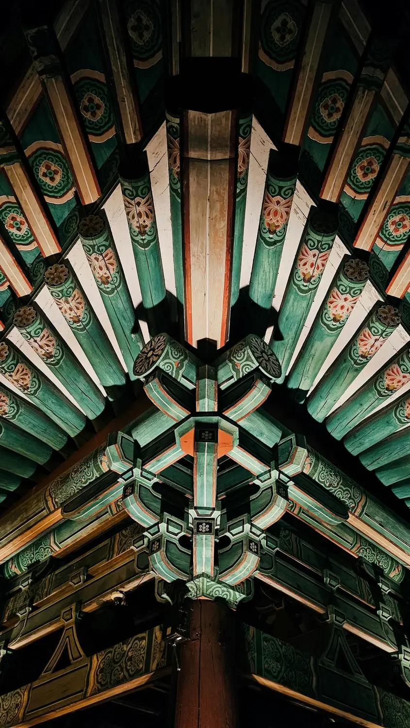 Close-up of the intricately painted underside of a traditional Korean temple roof showing colorful dancheong woodwork.