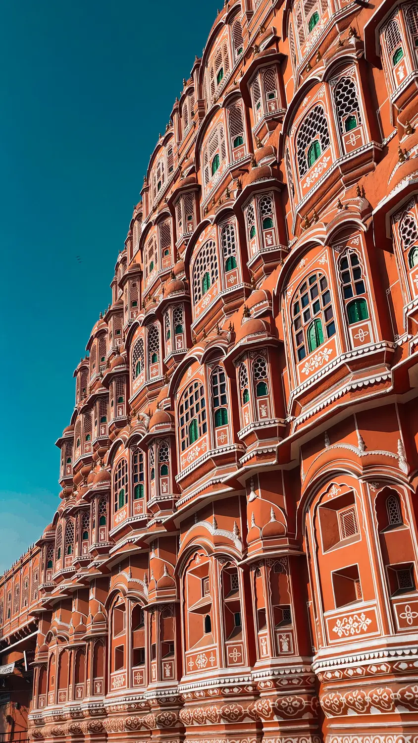 Hawa Mahal Palace of Winds pink sandstone honeycomb facade with ornate windows, Jaipur, Rajasthan, India