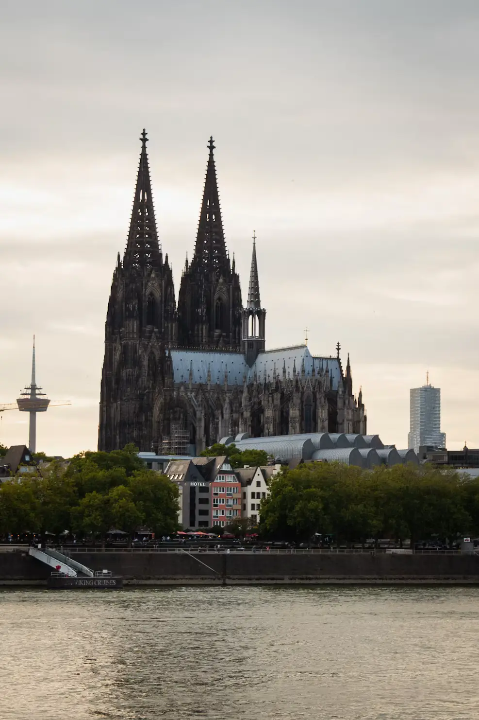 Cologne Cathedral skyline viewed across the Rhine River at dusk