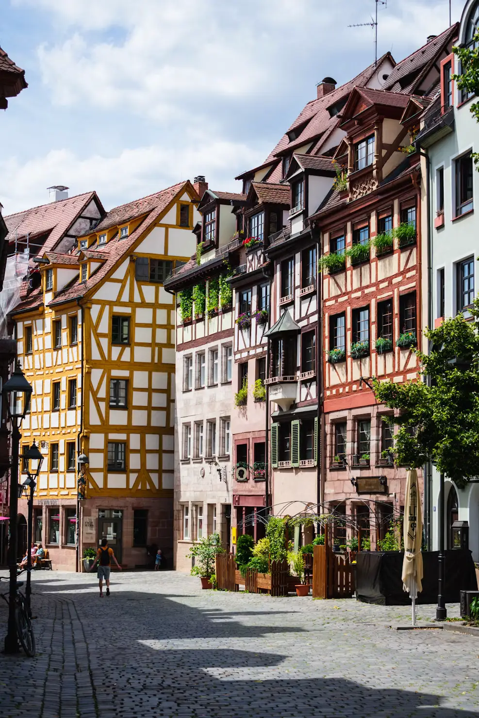 Colorful half-timbered houses lining a cobblestone street in a German old town