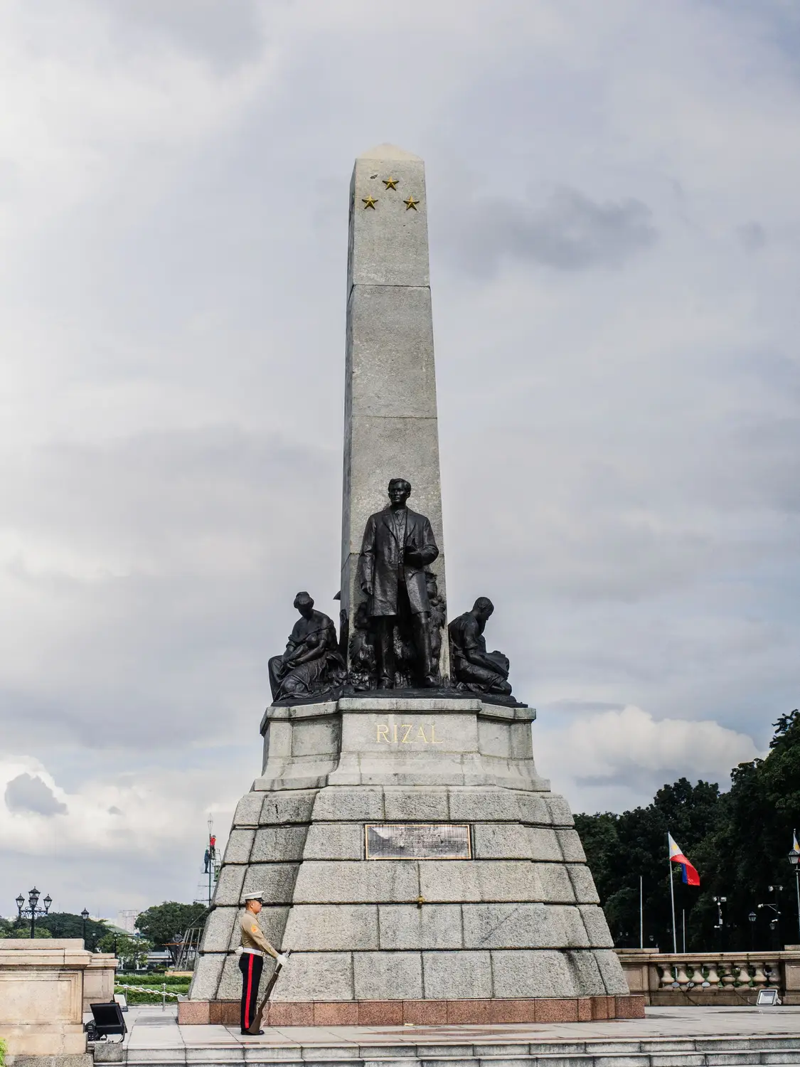 Rizal Monument with statues and an obelisk in Rizal Park, Manila, Philippines.