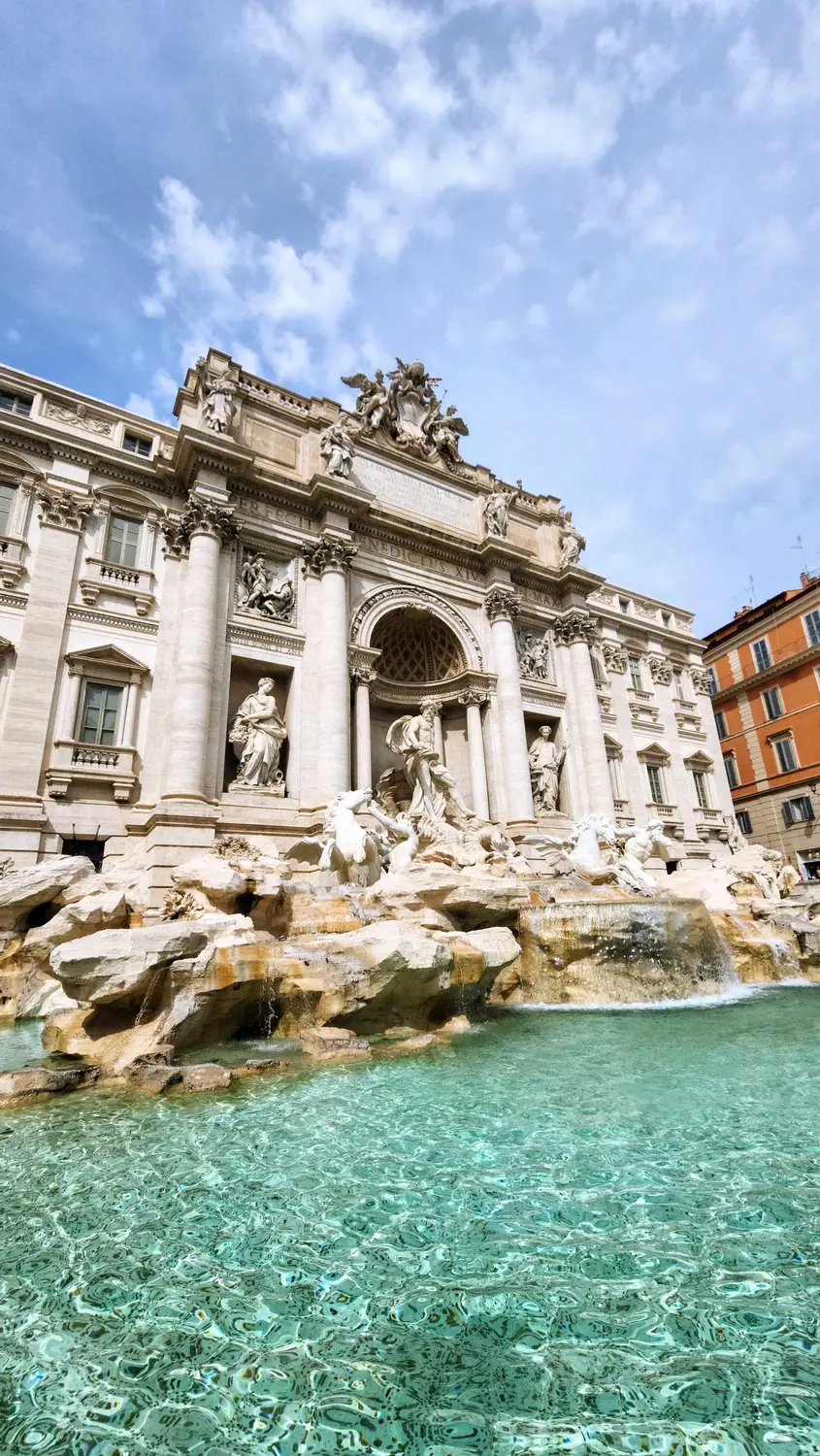Trevi Fountain in Rome with turquoise water and Baroque sculptures