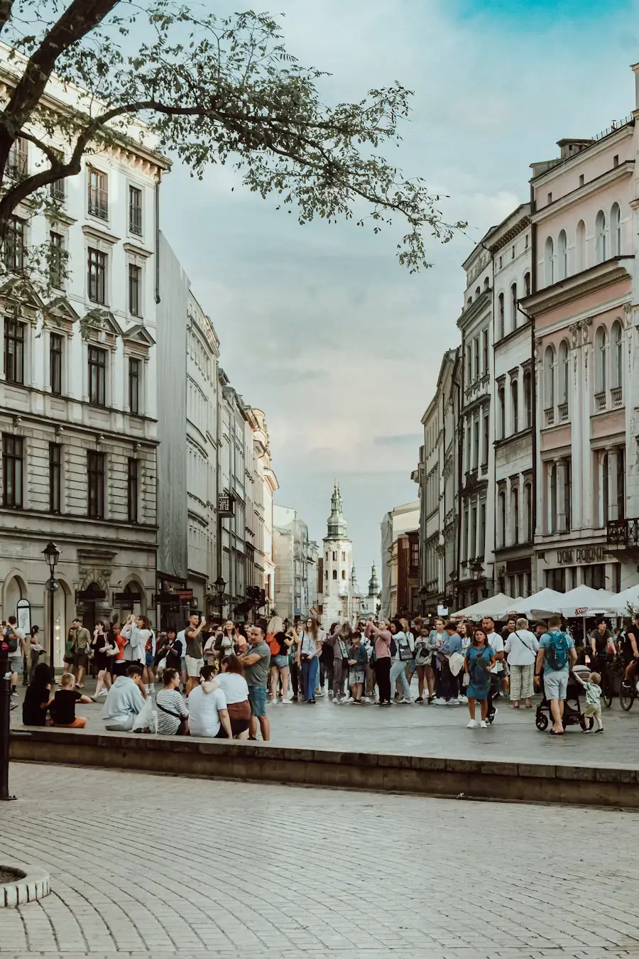 Busy European city square surrounded by historic buildings and pedestrians.