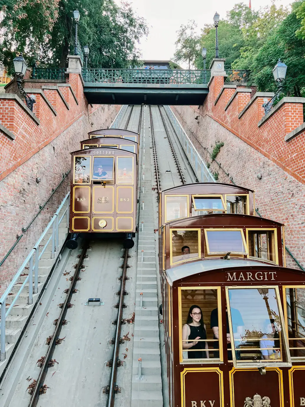 Historic funicular cars ascending the steep track to Buda Castle.
