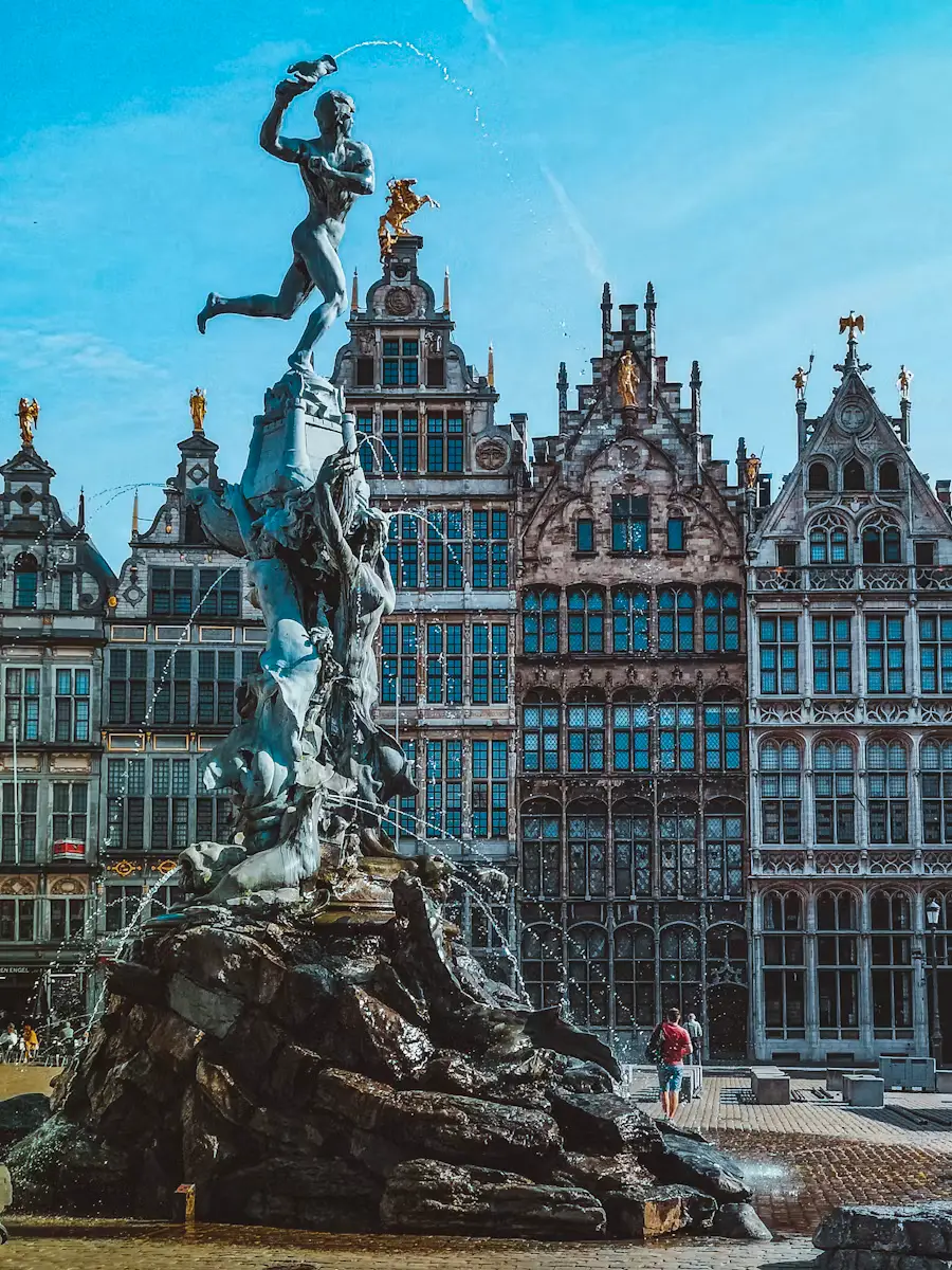 Brabo Fountain statue in Antwerp's Grote Markt square, framed by ornate historic guildhall facades