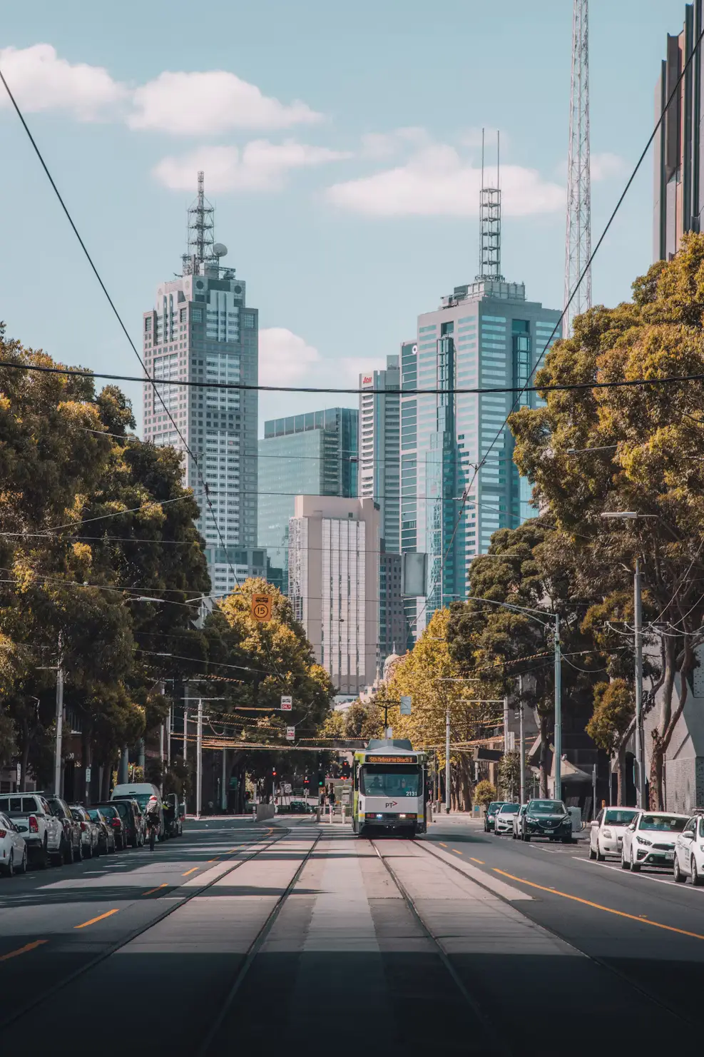 City street lined with skyscrapers and tram tracks in an Australian CBD