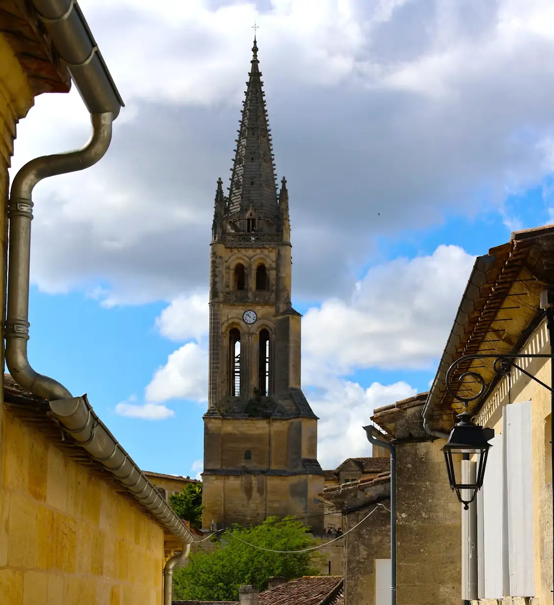 Gothic church bell tower rising above traditional stone houses in Saint-Émilion, France