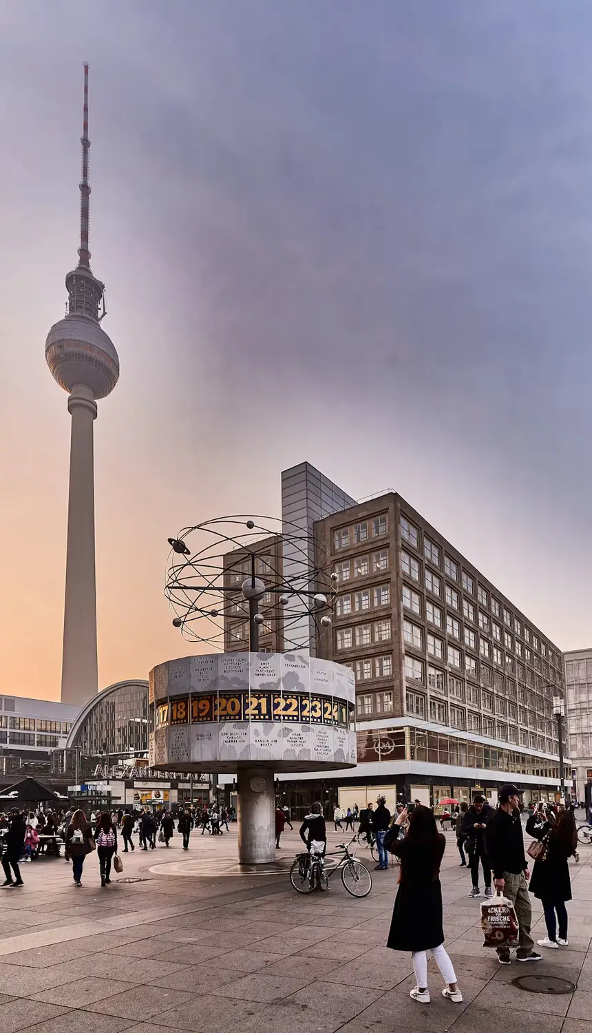 Berlin TV Tower (Fernsehturm) rising above a busy street with pedestrians