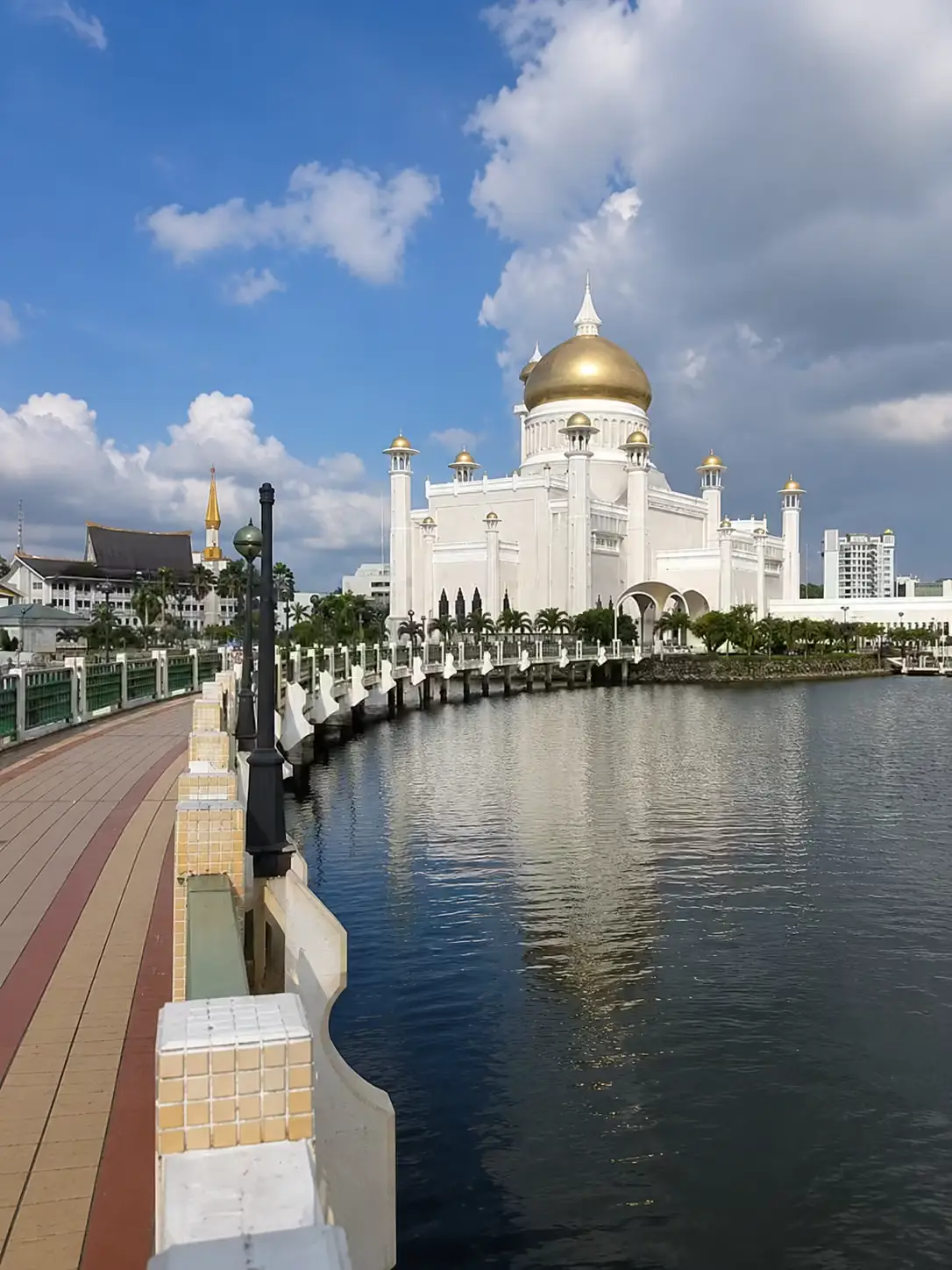 Sultan Omar Ali Saifuddien Mosque white marble exterior with golden dome reflecting in lagoon, Bandar Seri Begawan, Brunei