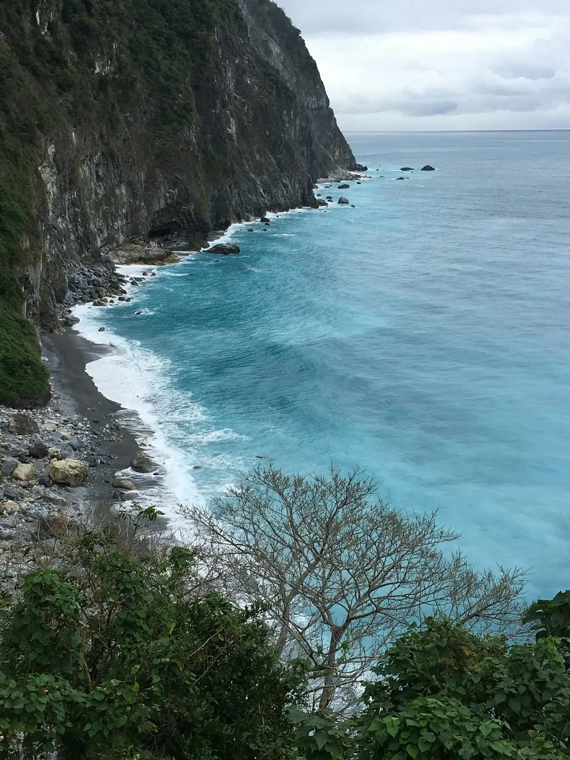 Steep Cliffs dropping into turquoise Pacific Ocean waves along Taiwan's east coast