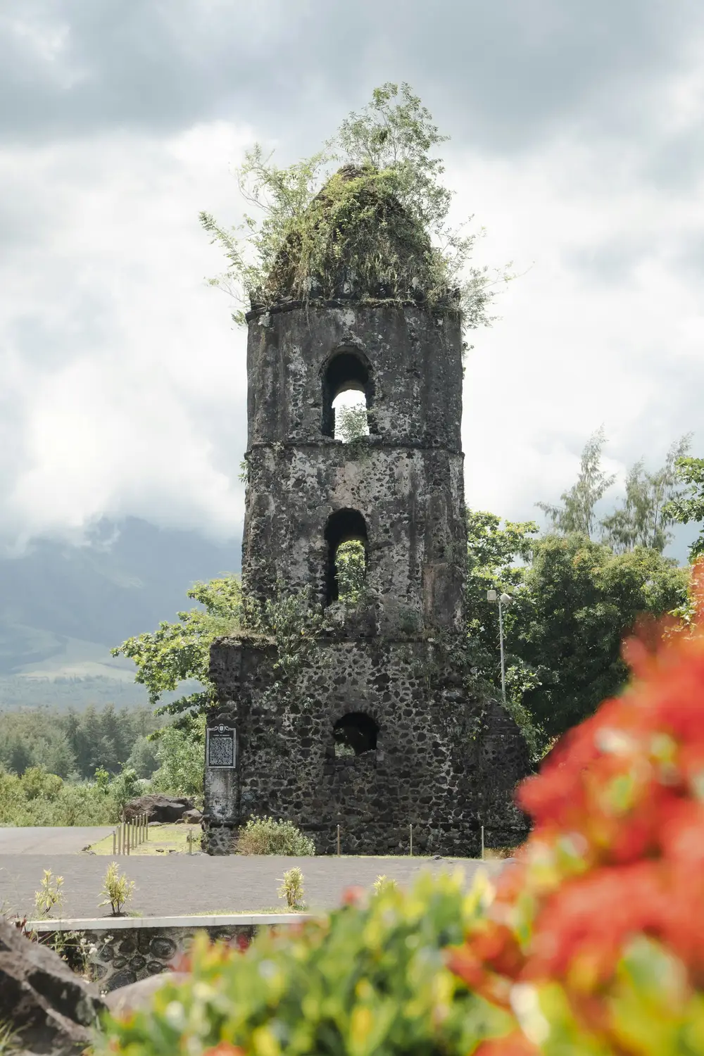 Ruins of the Cagsawa Bell Tower against a cloudy sky in Albay, Philippines.