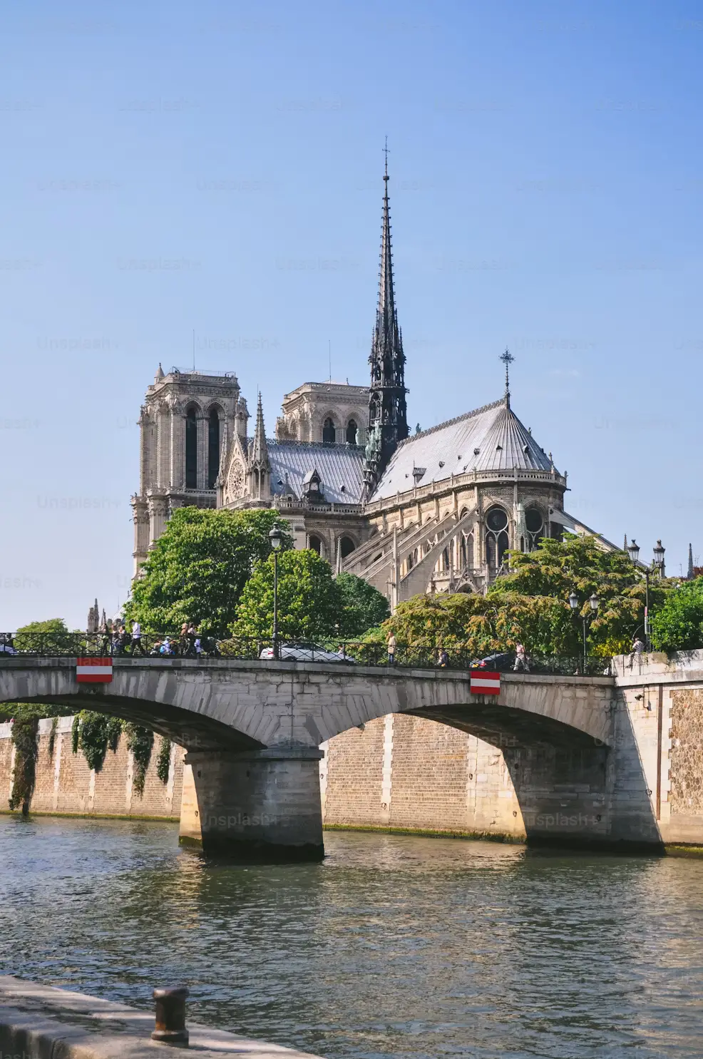 Notre-Dame Cathedral and its spire seen from across the Seine River in Paris