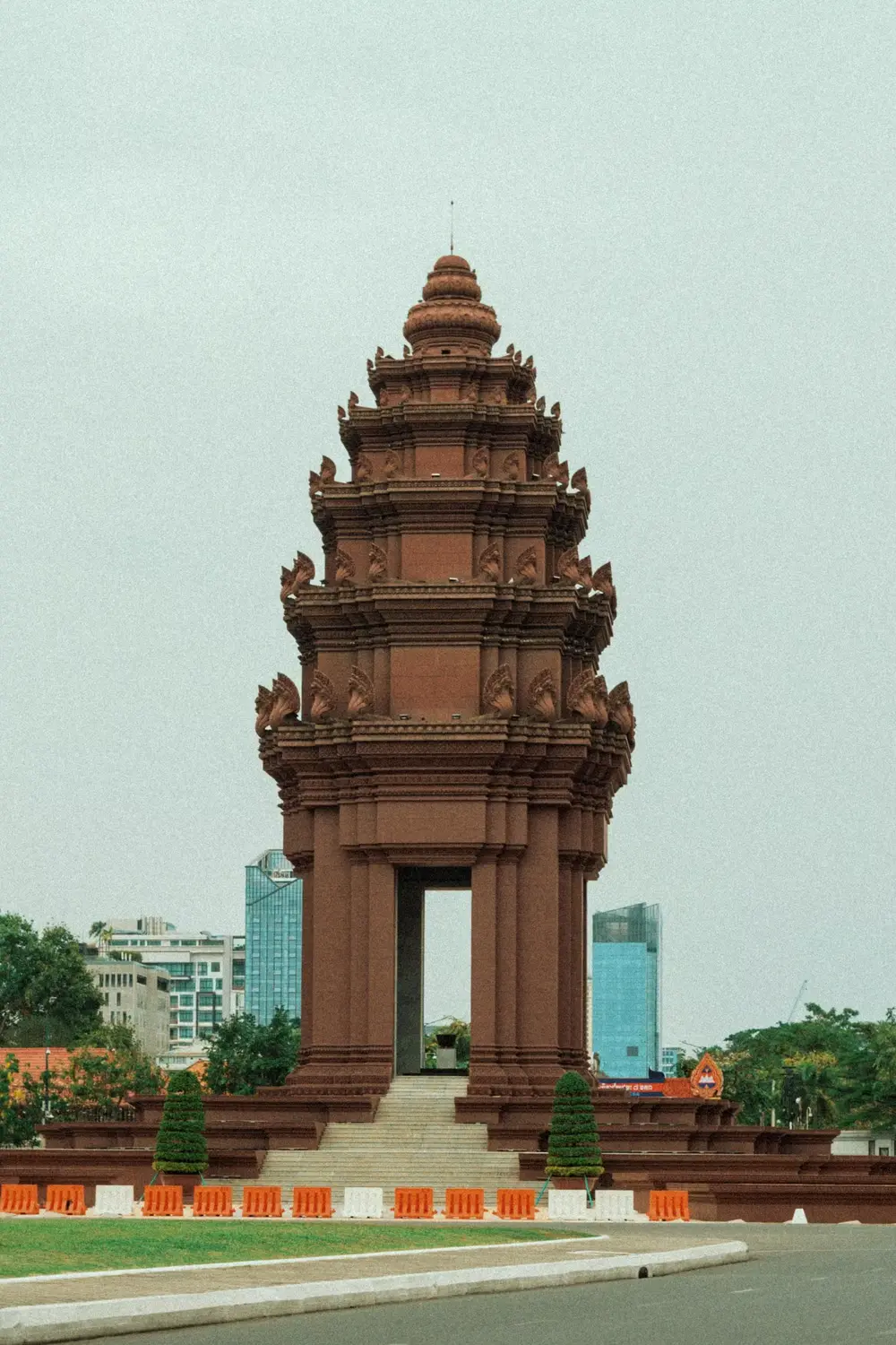 Independence Monument red brick stupa tower with tiered Khmer architecture in Phnom Penh city center, Cambodia