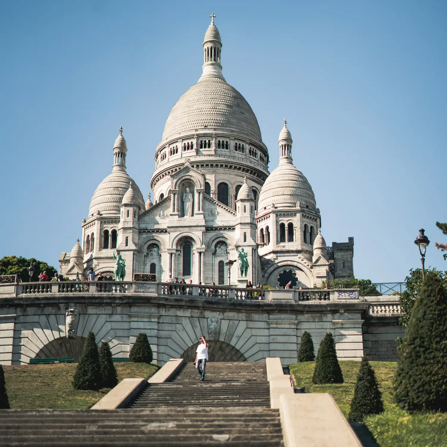 Sacré-Cœur Basilica white domes viewed from the stairway in Montmartre, Paris