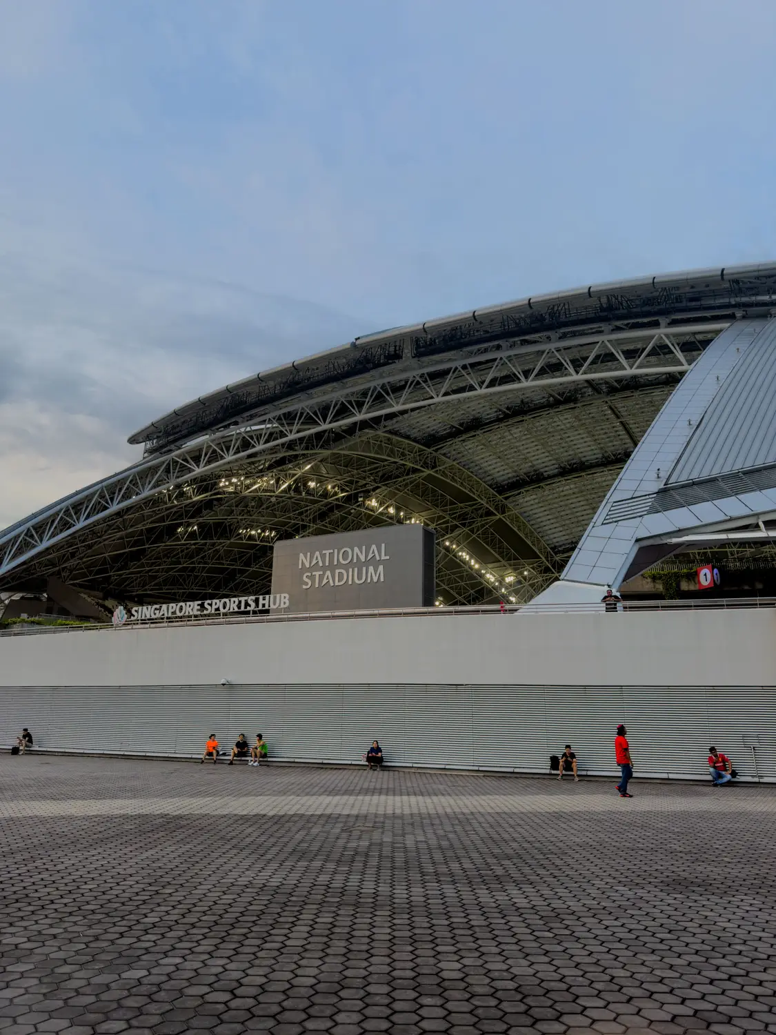 Low angle view of Esplanade Theatres on the Bay curved steel and glass roof architecture with lone visitor Singapore