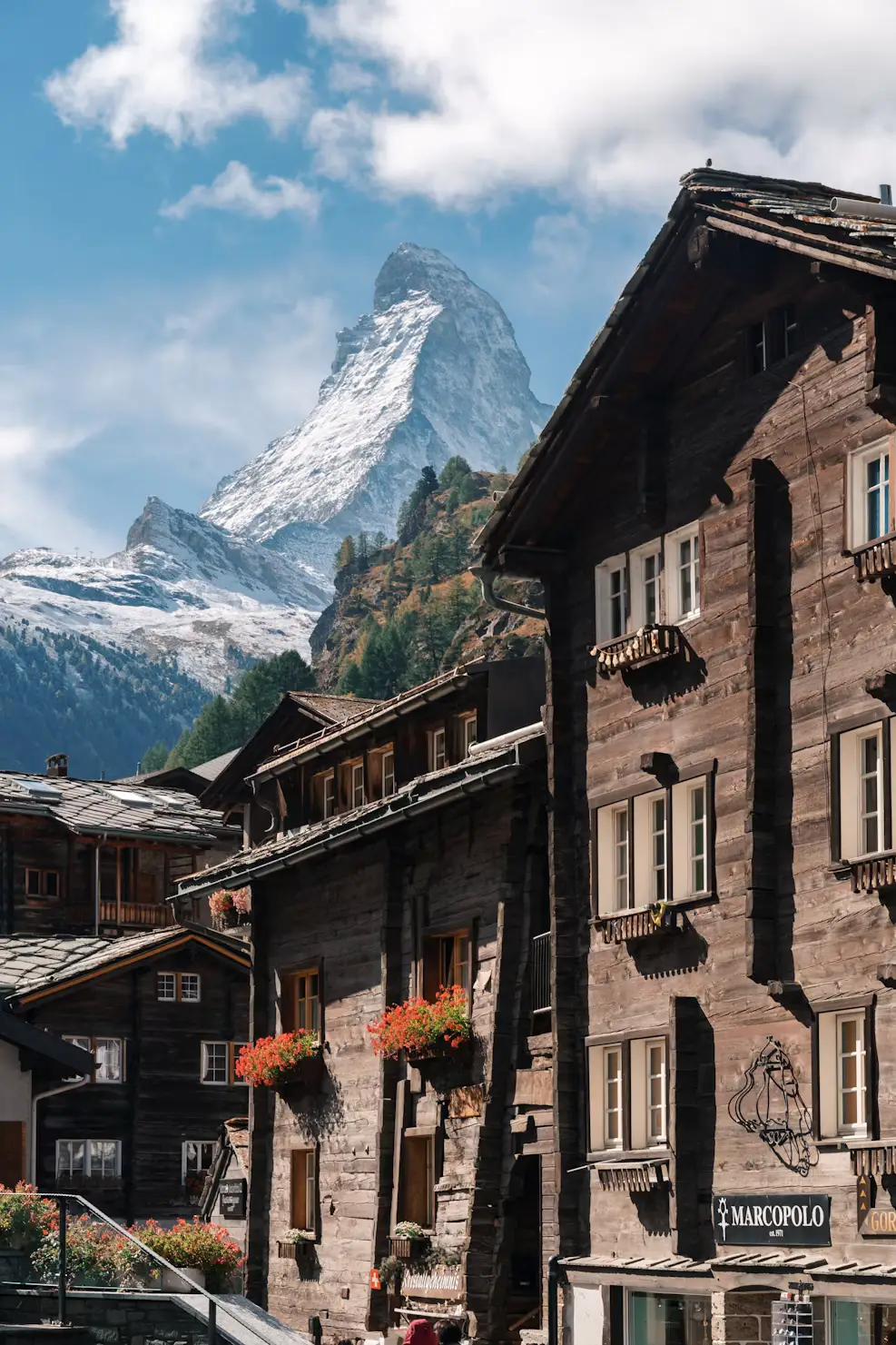 Traditional stone buildings with the Matterhorn mountain peak in the background, Zermatt, Switzerland