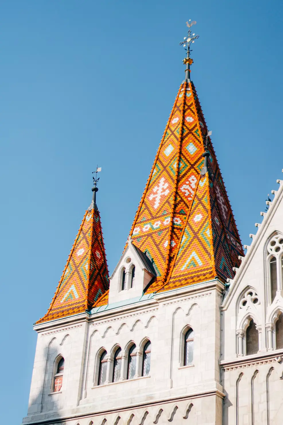 Close-up of the church’s colorful Zsolnay tile roof and Gothic spires.