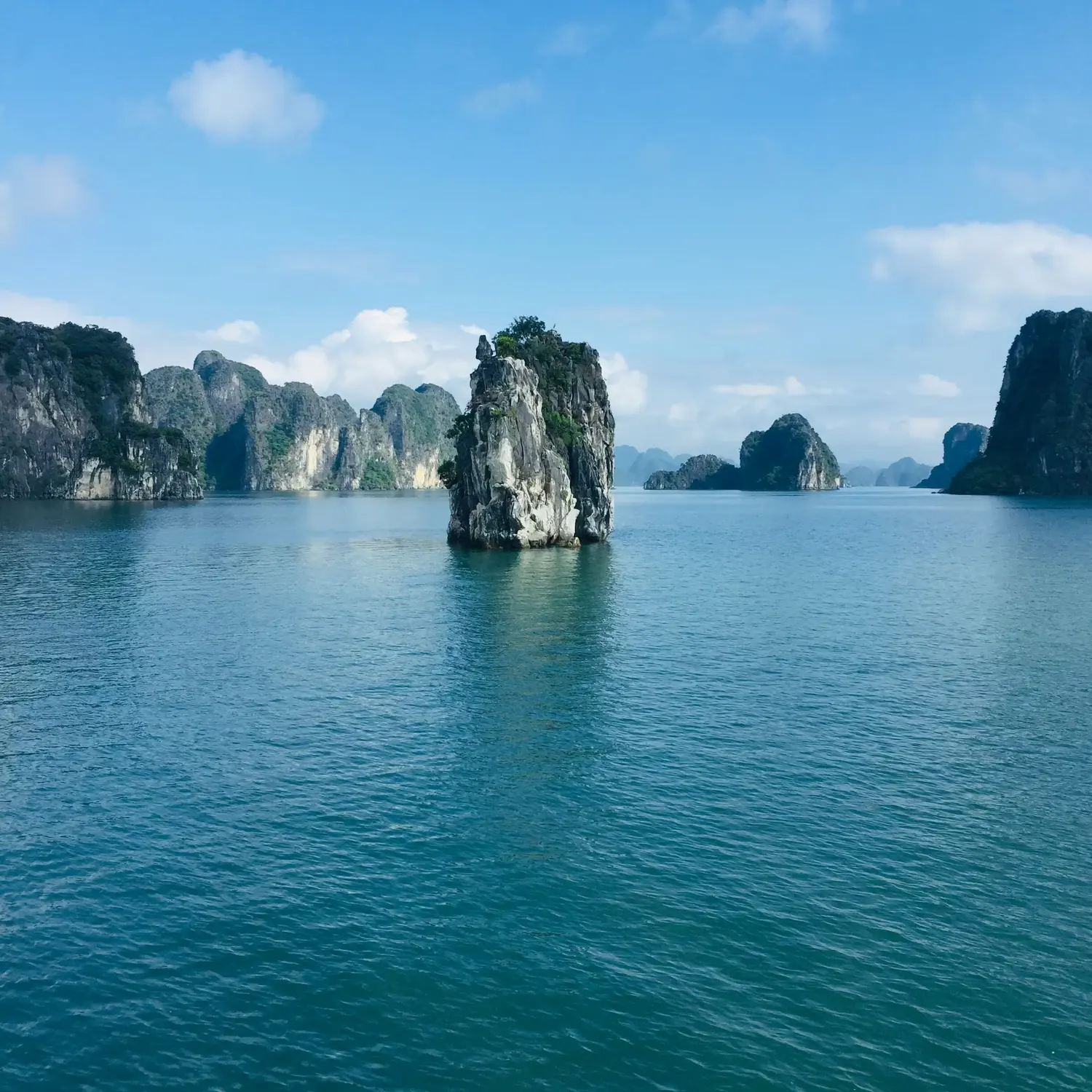 Limestone karst islands rising from the emerald waters of Ha Long Bay, Vietnam