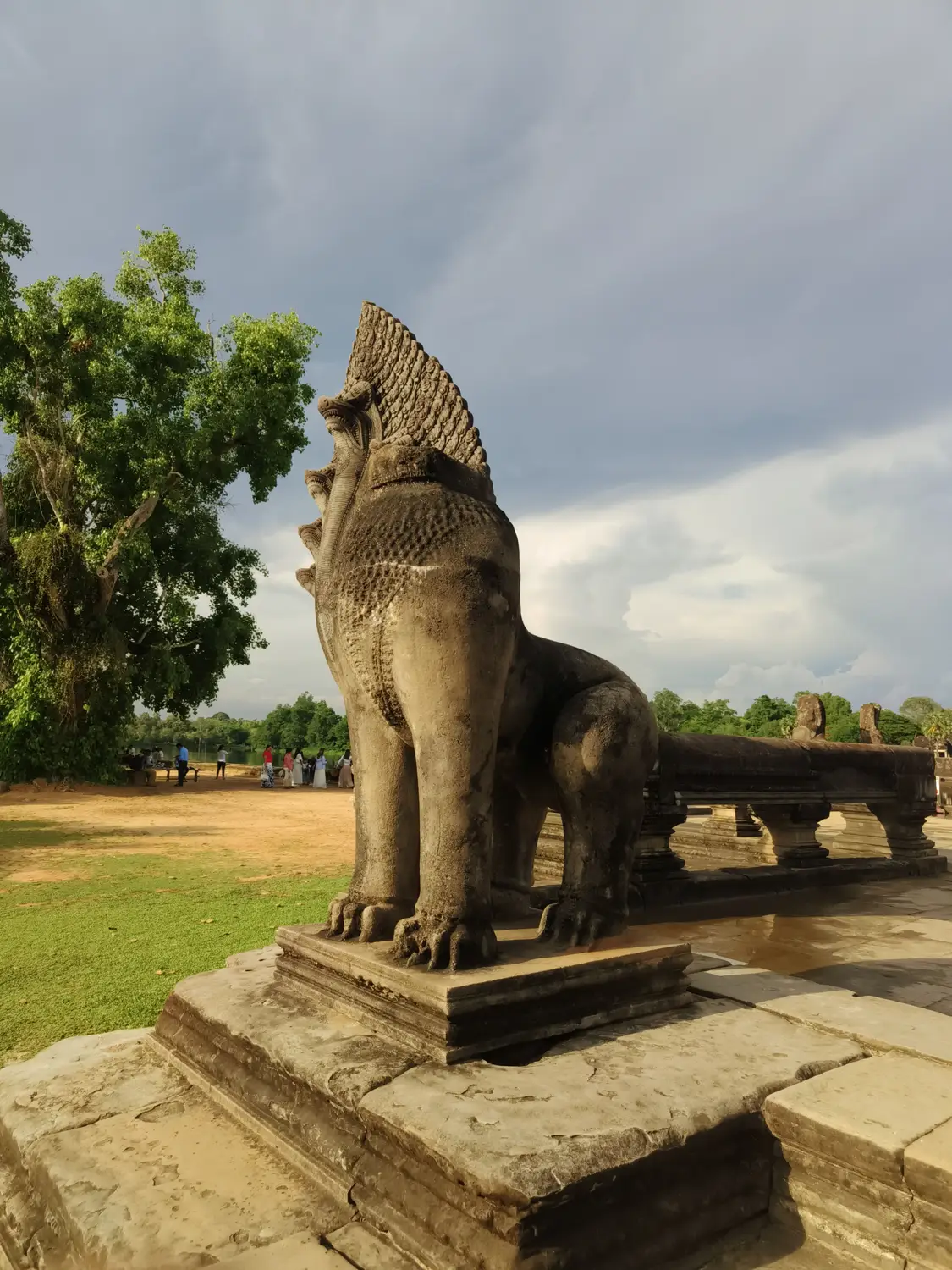 Ancient stone lion guardian statue at the entrance causeway of Angkor Wat temple complex, Siem Reap, Cambodia