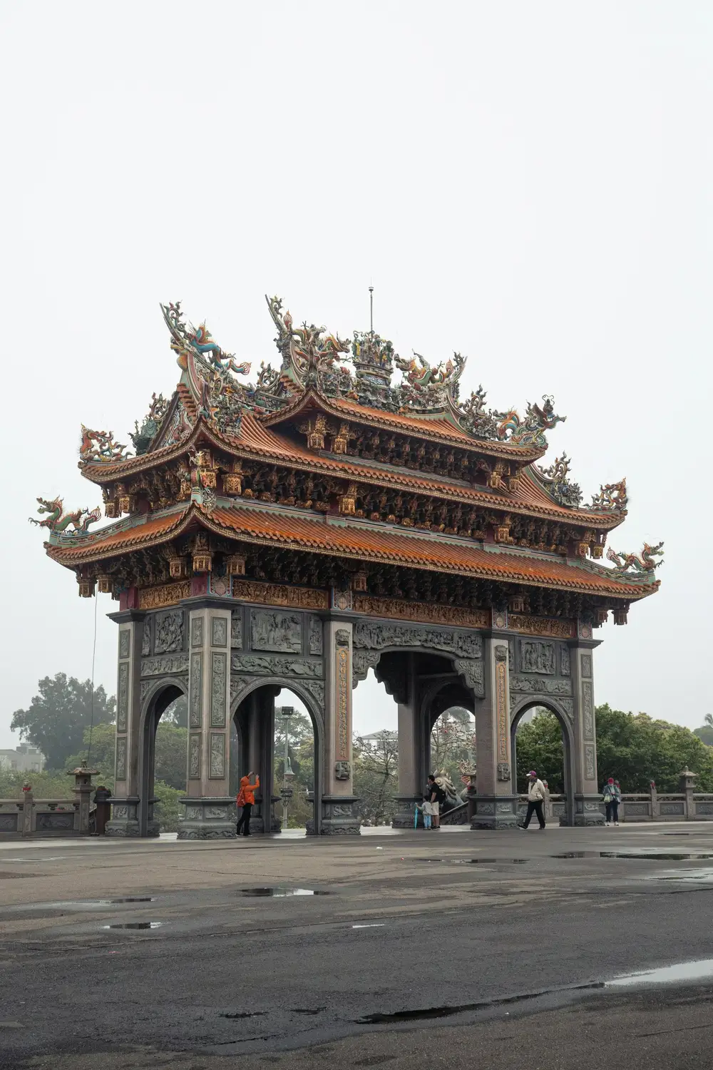National Theater in Taipei with traditional red-columned Chinese palace architecture, a tiled roof, and red flower beds in the foreground