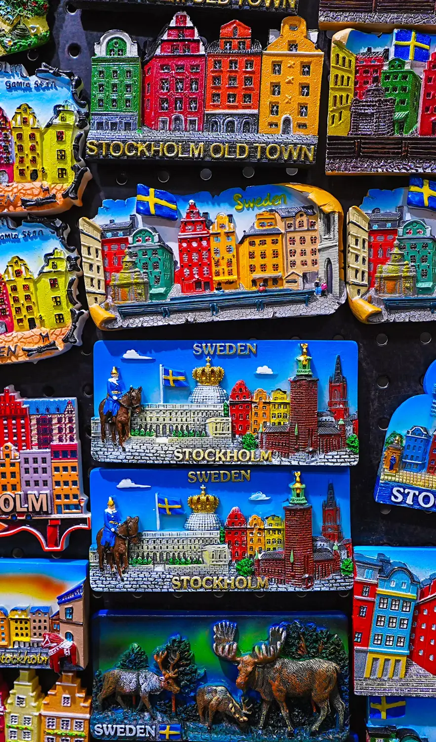Grid of colorful souvenir magnets depicting Stockholm Old Town landmarks and Swedish scenes.