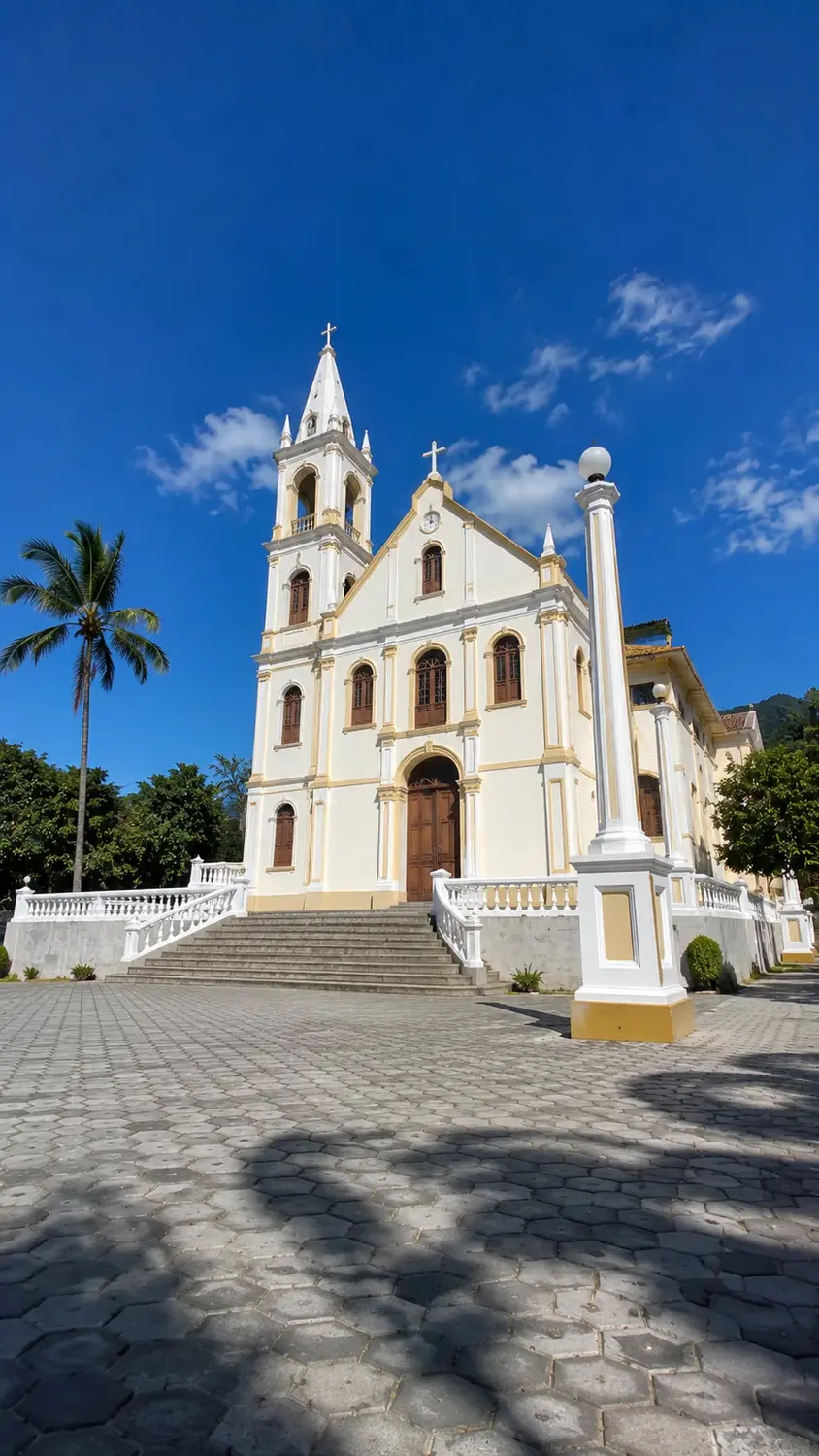 Historic white Catholic church with palm trees under blue sky Timor-Leste