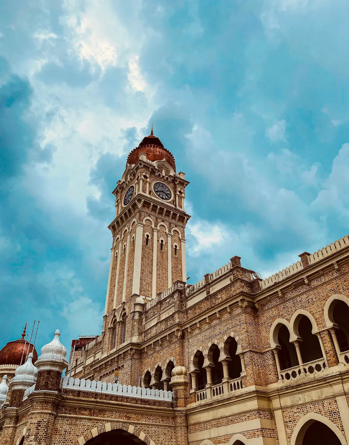 Sultan Abdul Samad Building clock tower with Moorish architecture facade and blue sky in Kuala Lumpur Malaysia
