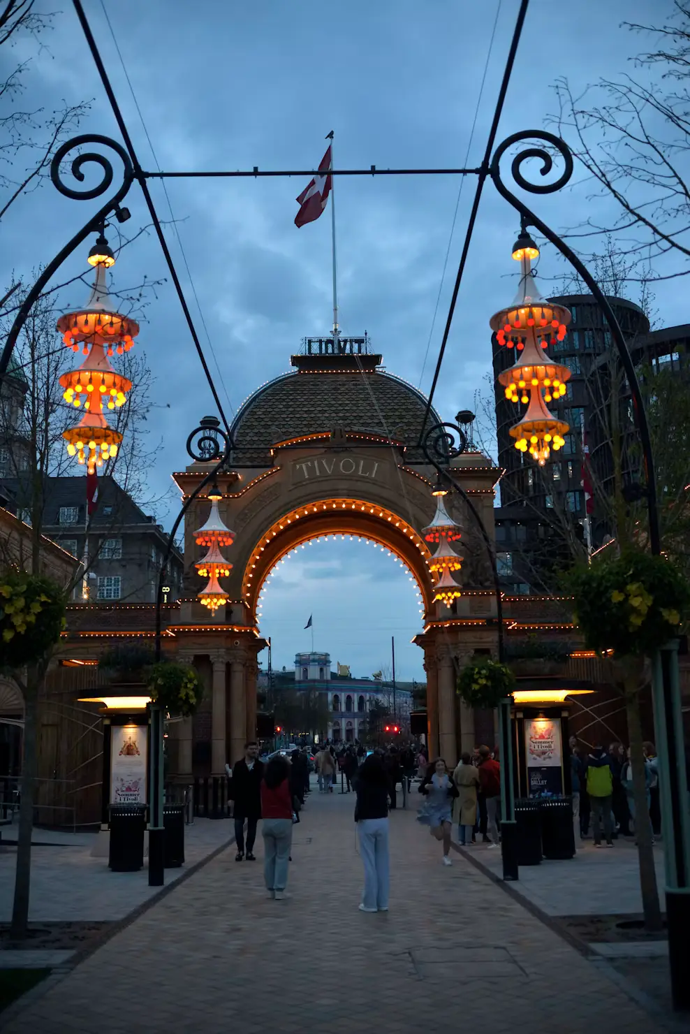 Illuminated entrance archway to Tivoli Gardens in Copenhagen at dusk